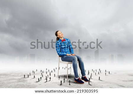 Woman in casual sitting on chair and small silhouettes of businesspeople around