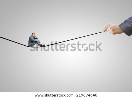 Young handsome businessman sitting on drawn line