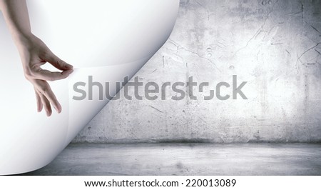Human hand turning white blank paper page