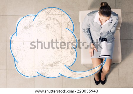 Top view of young businesswoman with megaphone sitting on chair