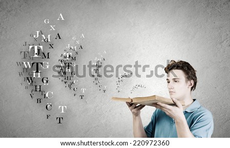 Young man with opened book in hands