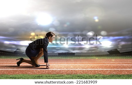 Side view of businesswoman at stadium standing in start position