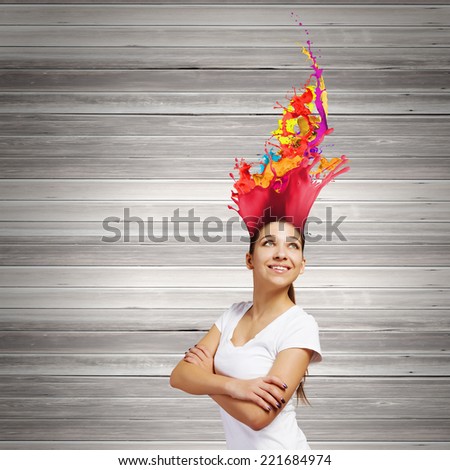 Young smiling woman with colorful thoughts above head