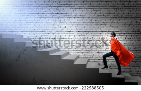Young superman walking up the stair case