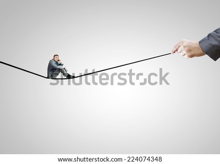 Young handsome businessman sitting on drawn line