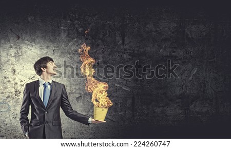 Young businessman hand holding yellow bucket in hand