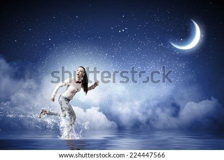 Young scared woman running at night under moon light
