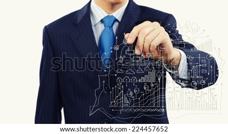 Close up of businessman drawing business sketches