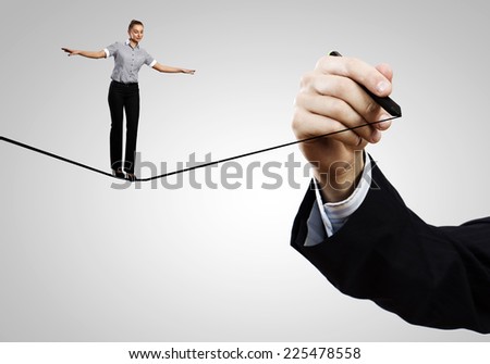 Young confident businesswoman standing on drawn line