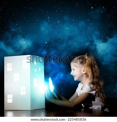 Little cute girl in darkness dreaming about home and family
