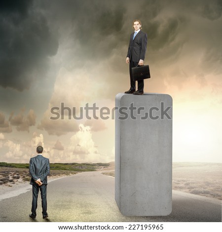 Businessman standing on bar and looking down at colleague