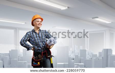 Young blond woman builder with projects in hand