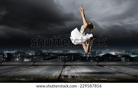 Young girl dancer jumping high in sky