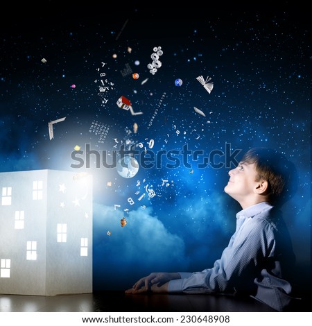 Cute little boy in dark room dreaming about home and family