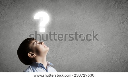 Young boy of school age looking question mark