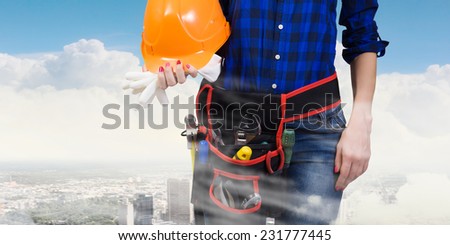 Close up of woman builder with hardhat in hands