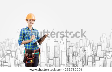 Young woman builder with folder in hand