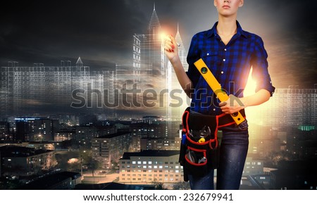 Close up of woman builder with ruler in hands