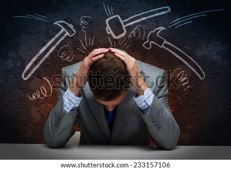 Depressed tired businessman with hands on head