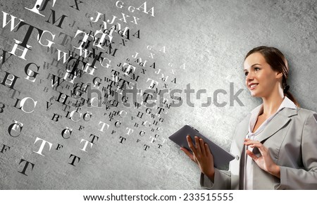 Young attractive woman in suit with tablet pc in hands