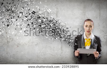 Young attractive woman in suit with tablet pc in hands