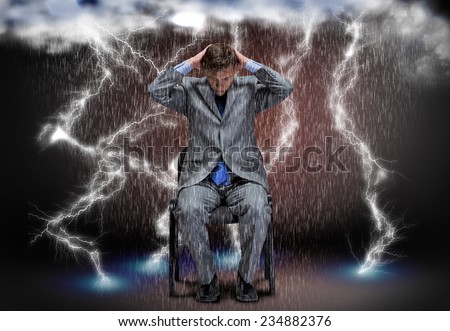 Conceptual image of troubled businessman sitting under rain