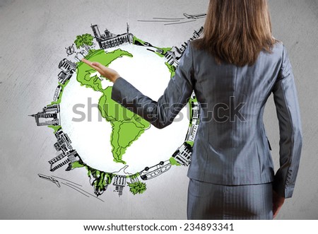 Rear view of businesswoman presenting drawn Earth planet