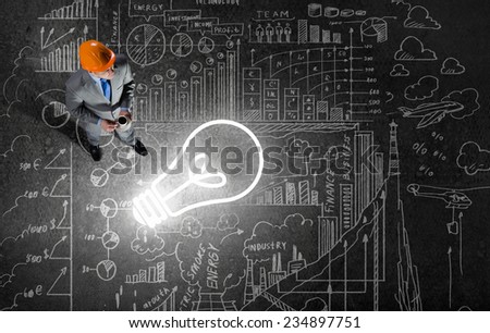 Top view of businessman looking at business sketches on floor