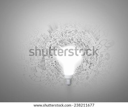 Conceptual image of light bulb and business sketches