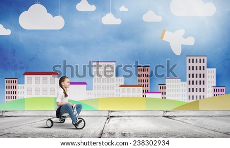 Cute girl against drawn background riding three wheeled bike