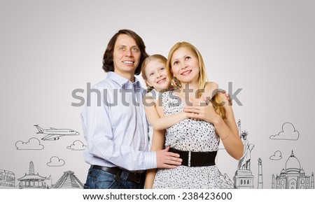 Happy family of three and sketches at background