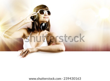 Young woman in white bikini wearing headphones. Place for text