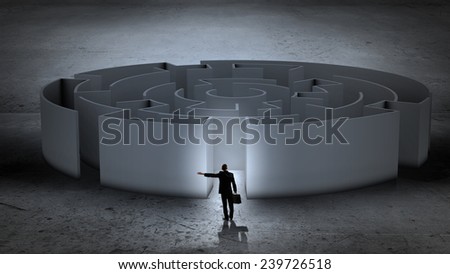 Puzzled businessman standing near entrance of labyrinth