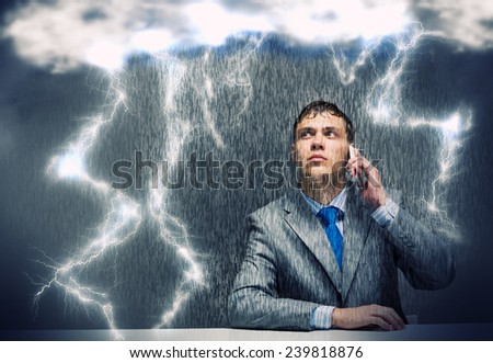 Young troubled wet businessman talking on phone
