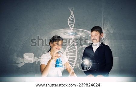 Young teacher and her pupil doing tests at chemistry lesson