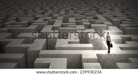 Puzzled businesswoman standing on top of labyrinth