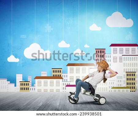Cute girl against drawn background riding three wheeled bike