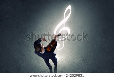 Top view of young businessman playing violin