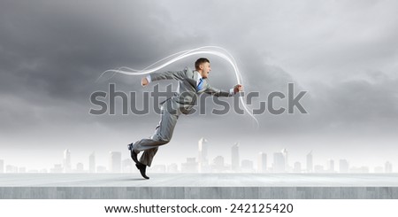 Cheerful young businessman running in a hurry