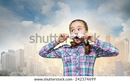 Cute girl wearing shirt and paper mustache