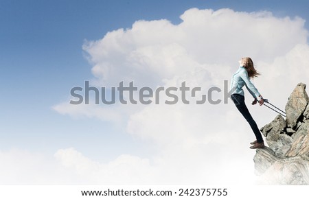 Young girl with ropes on hands trying to fly