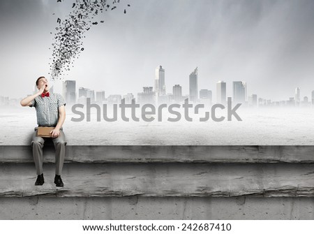 Young man student sitting with book in hands