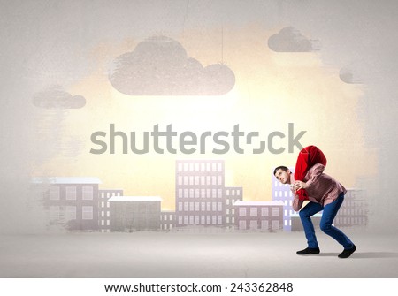 Young man in casual carrying heavy red bag
