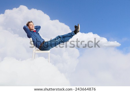 Young man sitting in chair with legs up and relaxing