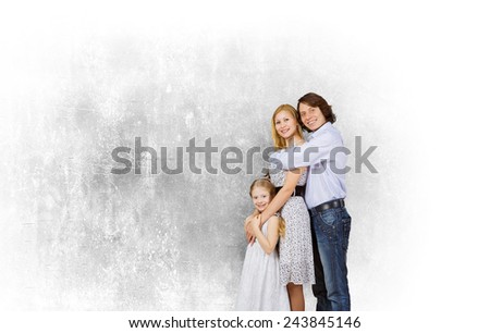Happy family of mother father and daughter against cement wall