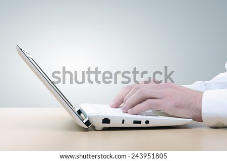 Close up of man\'s hands using laptop and splashes out of monitor