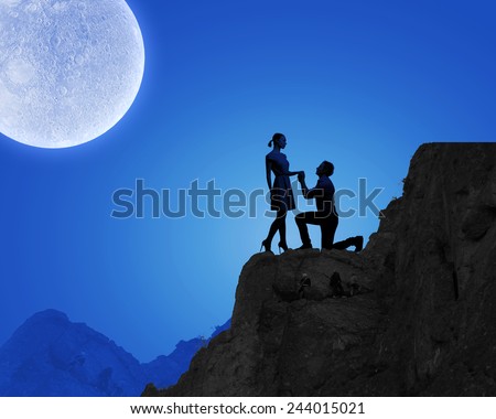 Silhouettes of romantic couple under the moon light