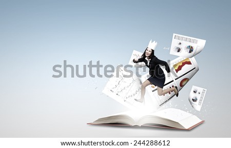 Young businesswoman in paper crown running in a hurry