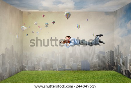 Businessman flying in sky and playing violin