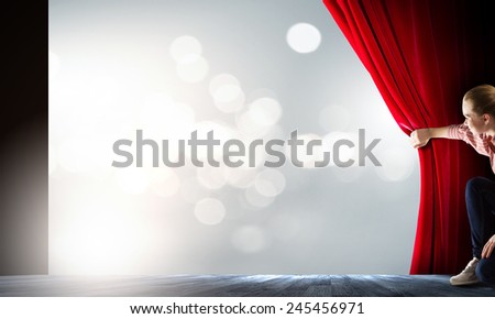 Young woman in casual with megaphone opening curtain